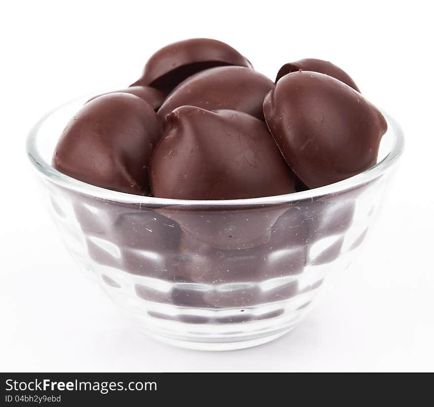 Chocolate candy in bowl on white