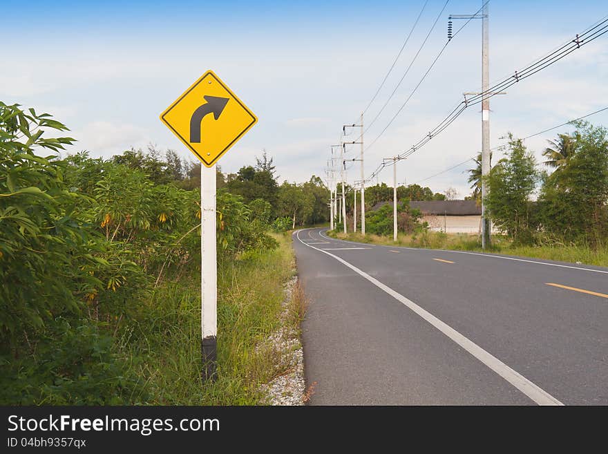 Traffic sign, right  way arrow with road and sky