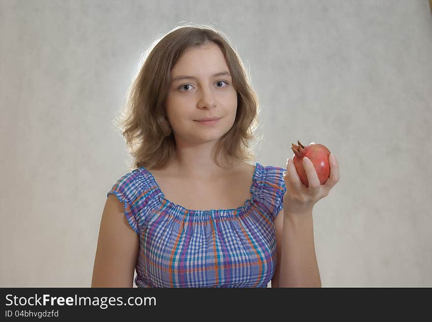 Girl holding pomegranate in the hand. Girl holding pomegranate in the hand