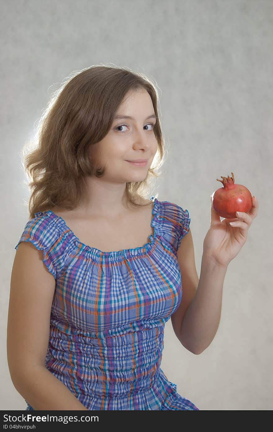 Girl offering pomegranate to spectators. Girl offering pomegranate to spectators