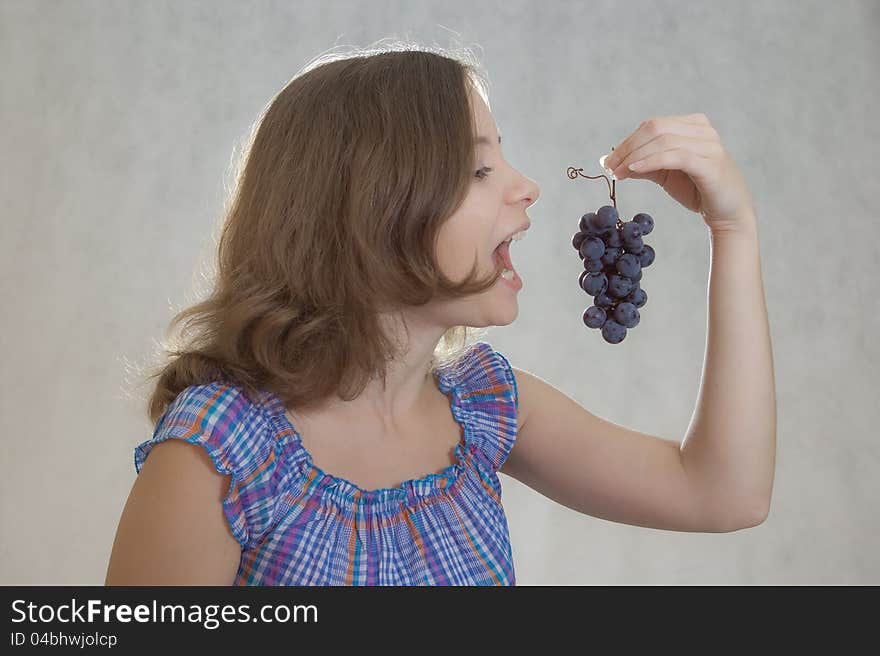 Girl with cluster of grapes