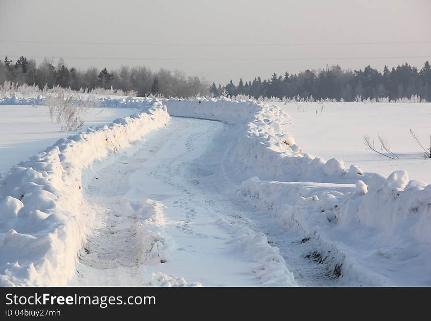 Country road covered with snow. Winter. Frost. Country road covered with snow. Winter. Frost.