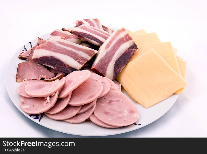 Sliced meat and cheers on the plate. Sliced meat and cheers on the plate