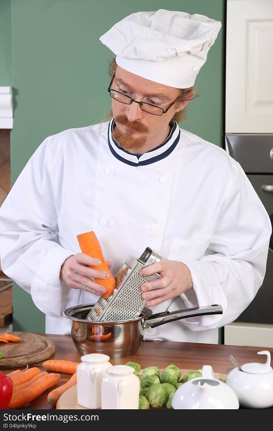 Young chef preparing lunch in kitchen