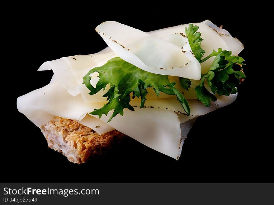 Cheese Sandwich with whole wheat bread and greens isolated on black background. Cheese Sandwich with whole wheat bread and greens isolated on black background