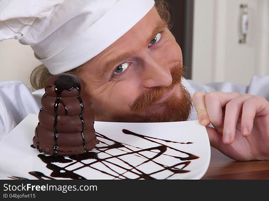 Young chef with piece of cake