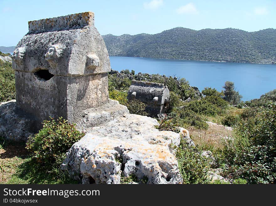 Taken on a walk along the Lycian way to Simena in Turkey. Shows a tomb surroundered by wild flowers on a hillside. Taken on a walk along the Lycian way to Simena in Turkey. Shows a tomb surroundered by wild flowers on a hillside.