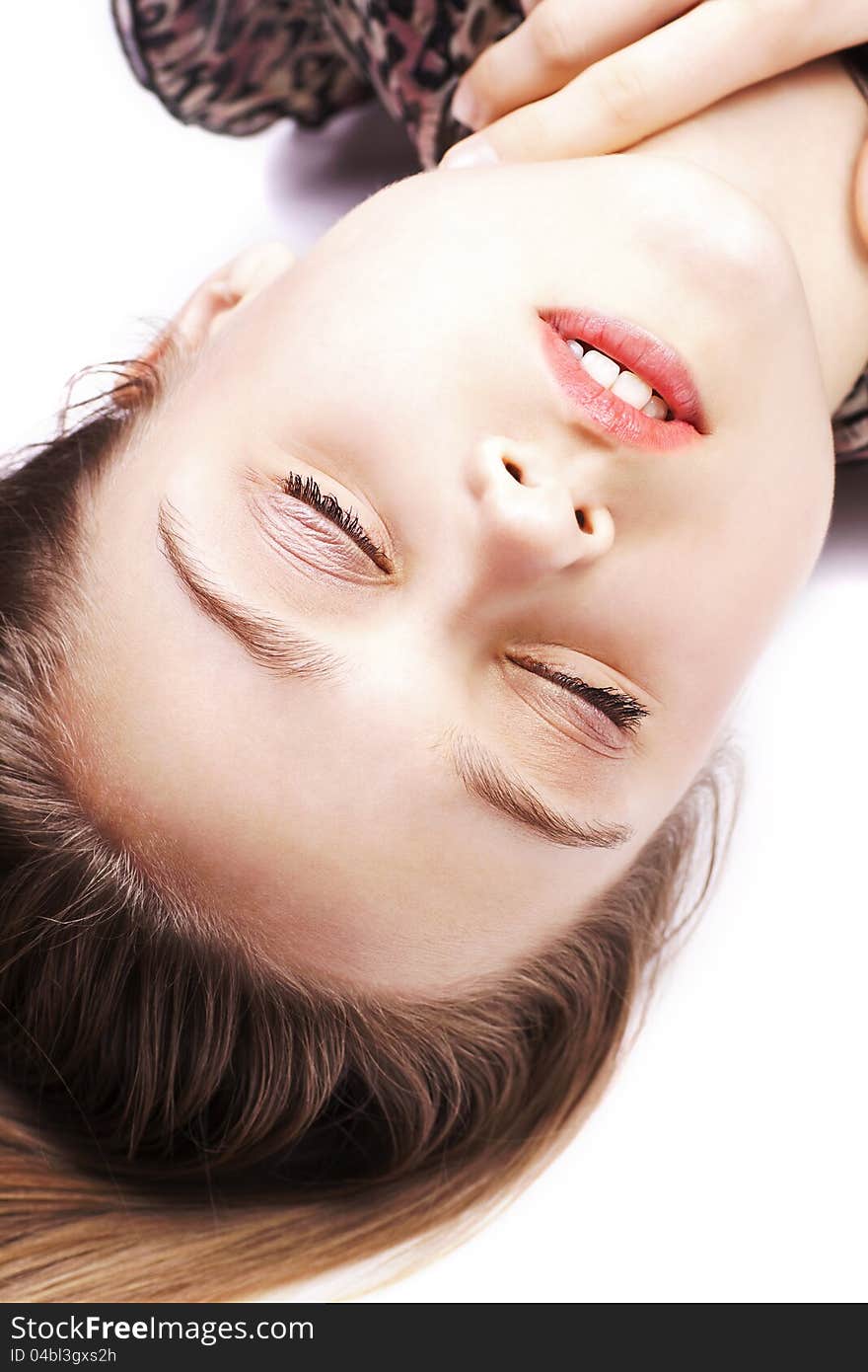 Closeup portrait of sensual young woman posing while lying on floor. Closeup portrait of sensual young woman posing while lying on floor