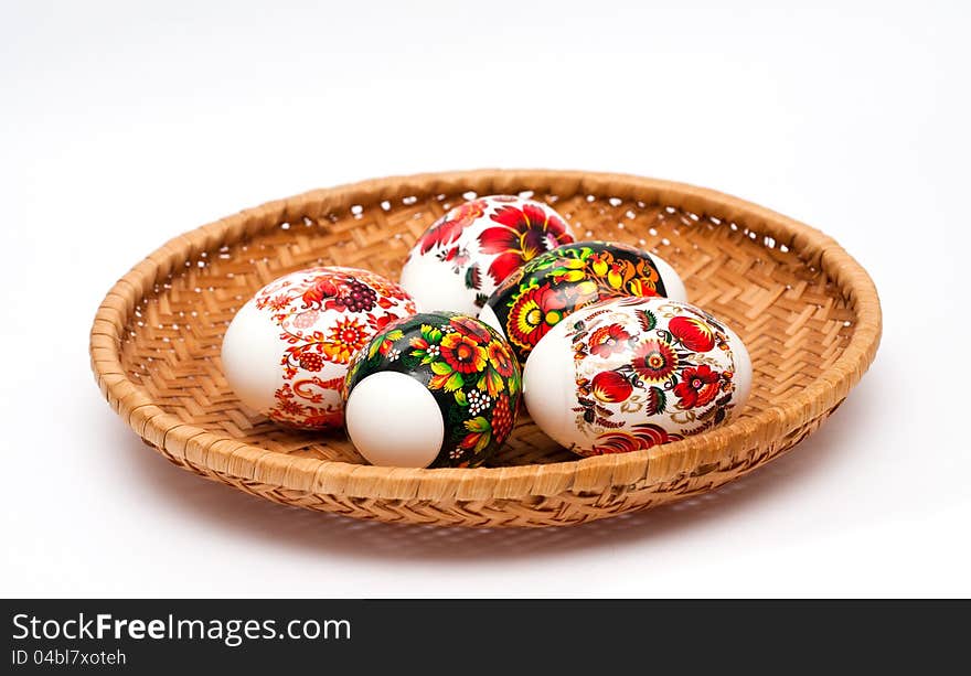 Easter eggs in basket at white