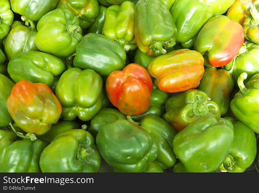 Bunch of Organic Green Bell Pepper.
Some of them have red coloration.