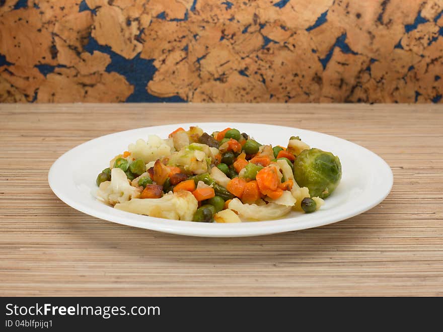 A plate with vegetables on the table