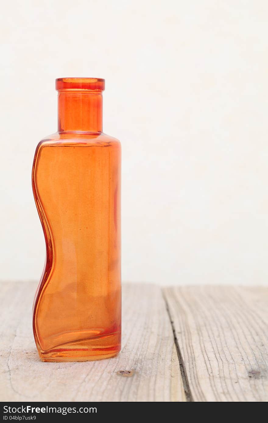 Old glass bottle on wooden table