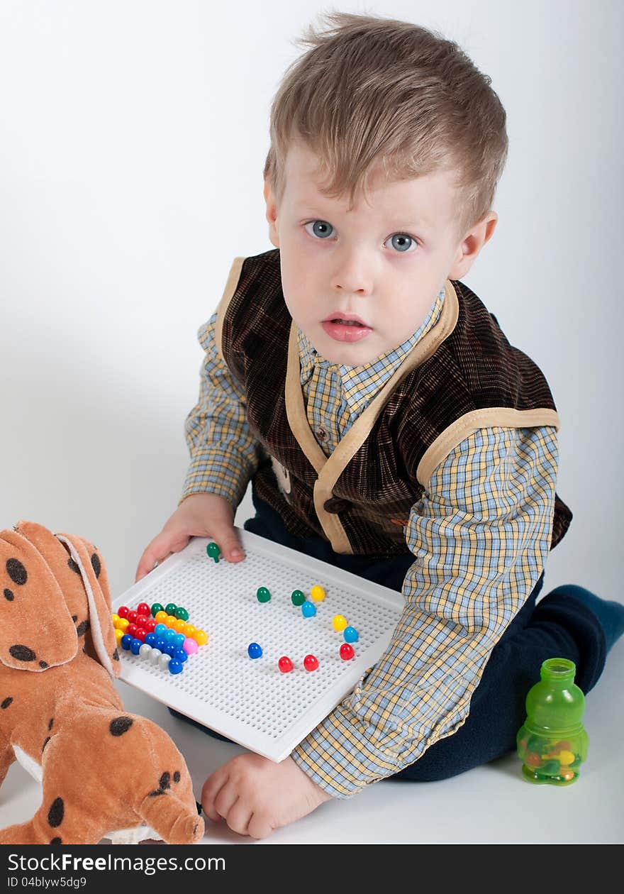 A Little Boy Playing With Mosaics