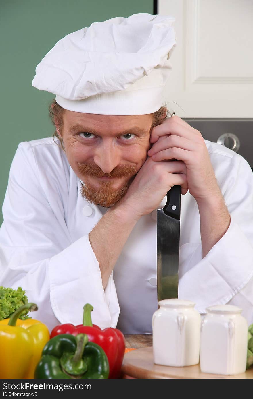 Chef With A Knife In Kitchen