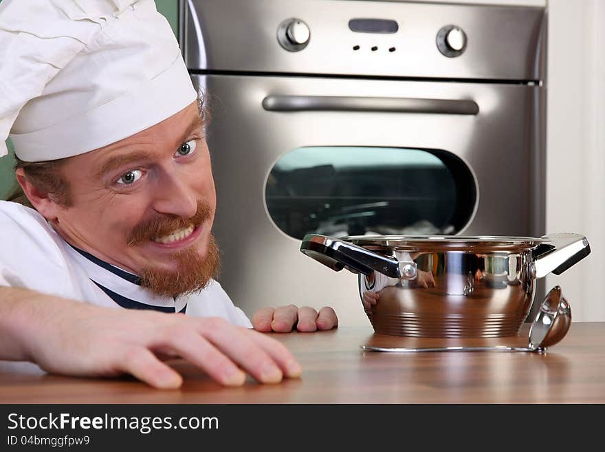 Funny young chef with a pot