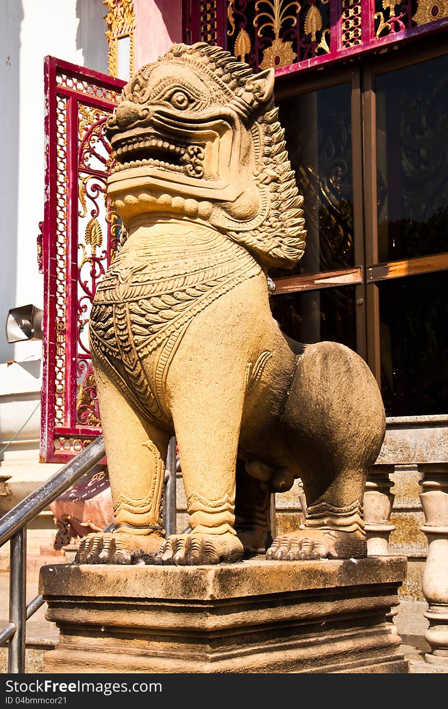 The lion statues made ​​of stone. Stand in front of a temple in Thailand at Phetchaburi province.