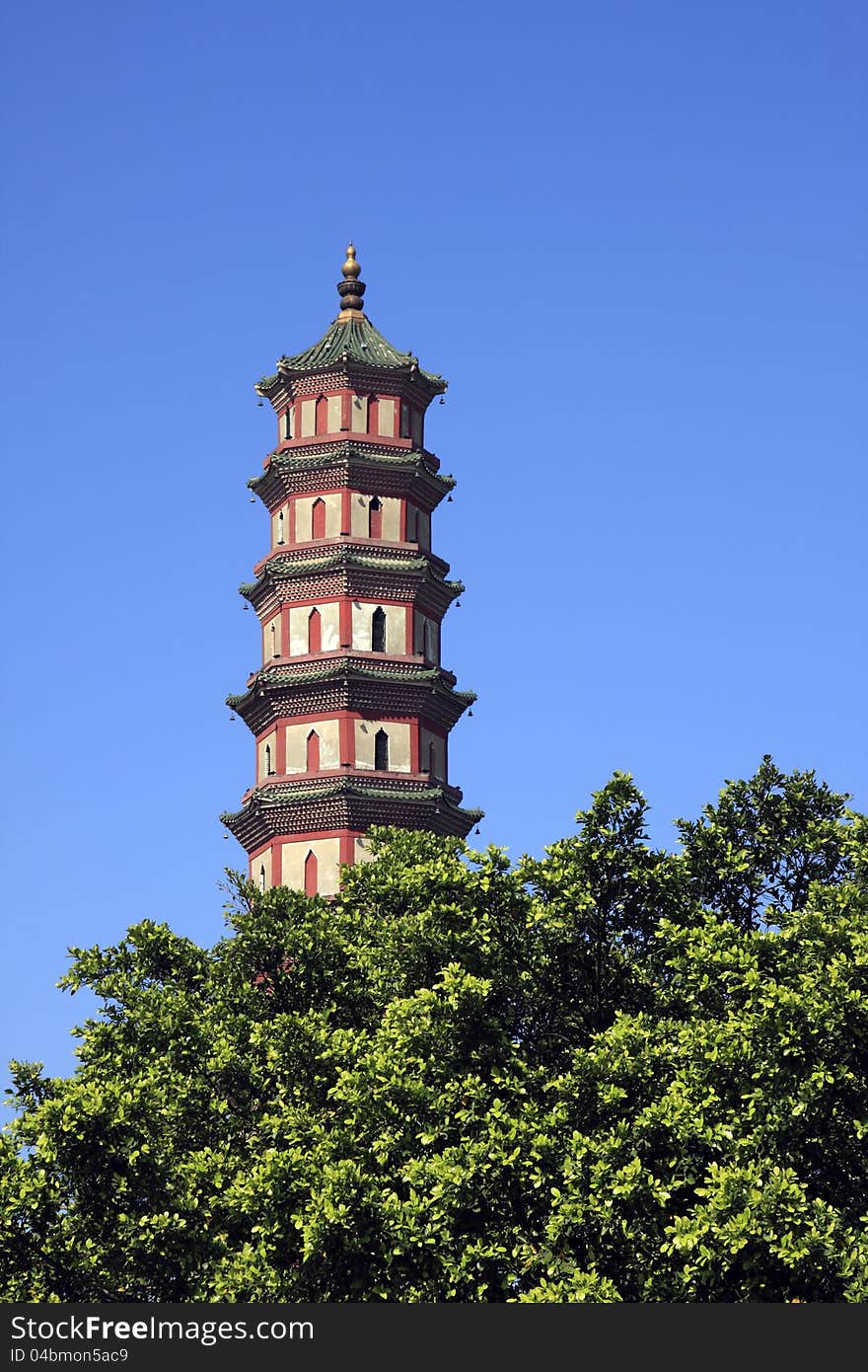 Chinese traditional pagoda against blue sky, with golden gourd on top and copper bells hanging on eaves. Chinese traditional pagoda against blue sky, with golden gourd on top and copper bells hanging on eaves.