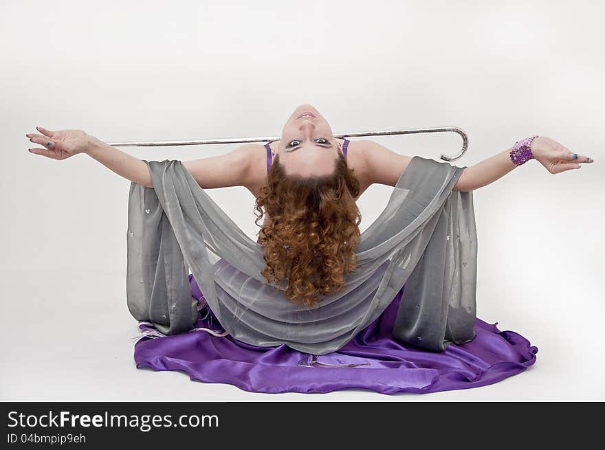 Pretty belly dancer posing on white background