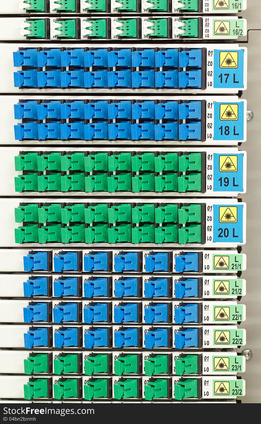 Fiber optic cable management system with green and blue SC connectors. Fiber optic cable management system with green and blue SC connectors