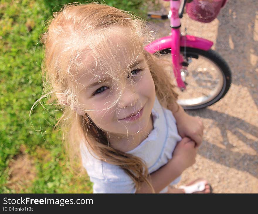 Sweet little girl outdoor with her bicycle. Sweet little girl outdoor with her bicycle