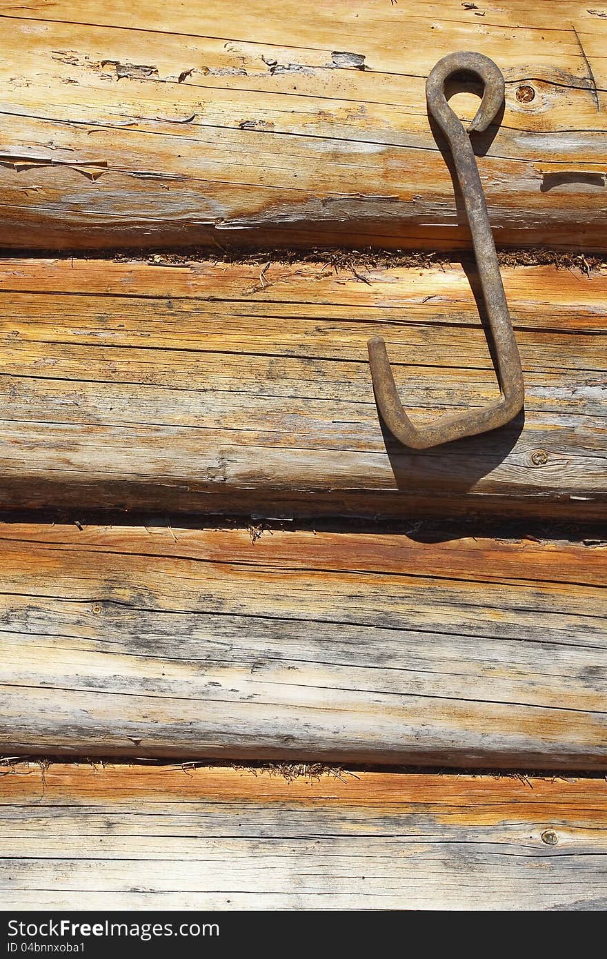 Fragment of wooden frame wall with an iron hook. Texture, background. Fragment of wooden frame wall with an iron hook. Texture, background