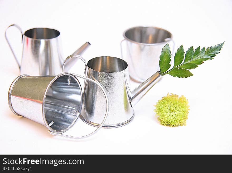 Watering can and bucket on white