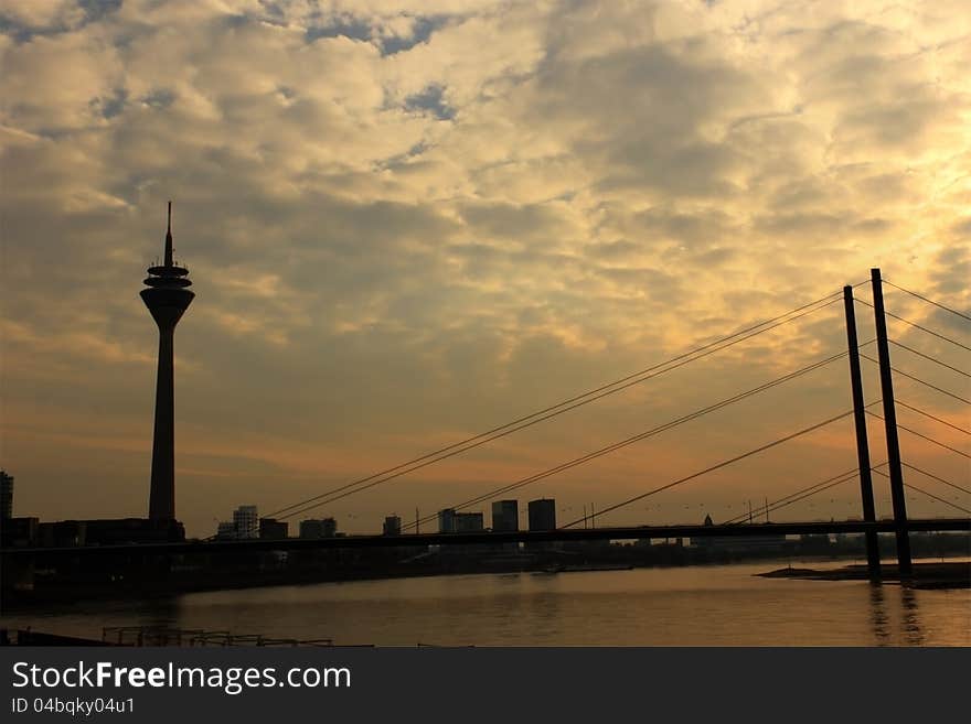 Dusseldorf skyline on the river Rhine, with the silhouette of the TV Tower, and Media Harbor in the back. HDR image. Dusseldorf skyline on the river Rhine, with the silhouette of the TV Tower, and Media Harbor in the back. HDR image