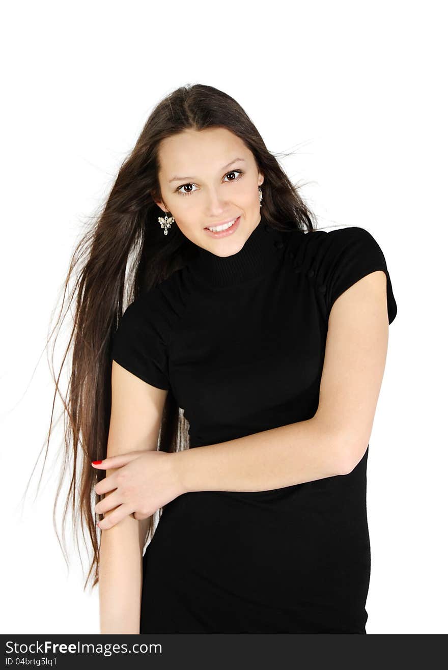 Beautiful brunette girl wearing black dress smiles in white studio