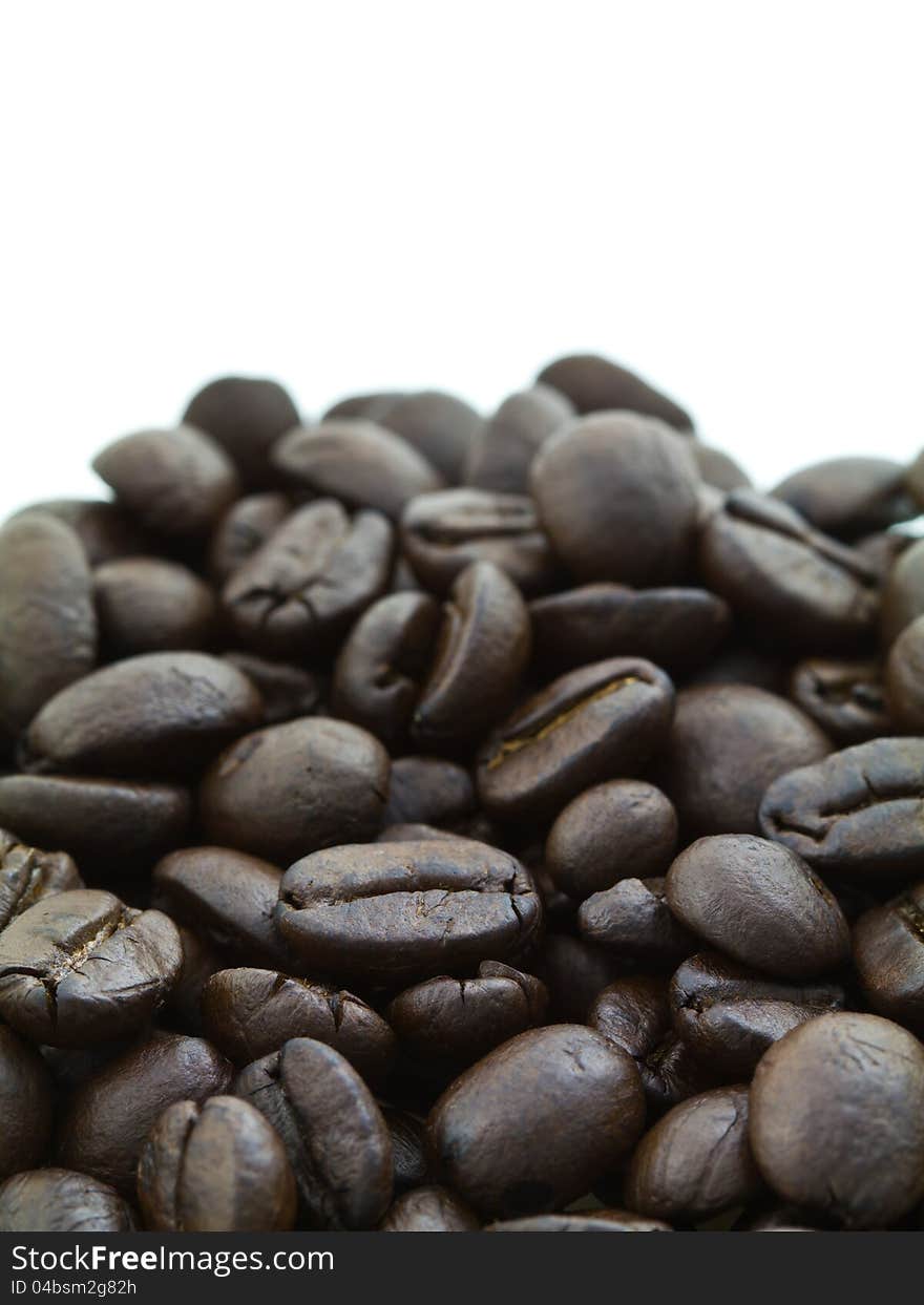 Pile of coffee beans on white background