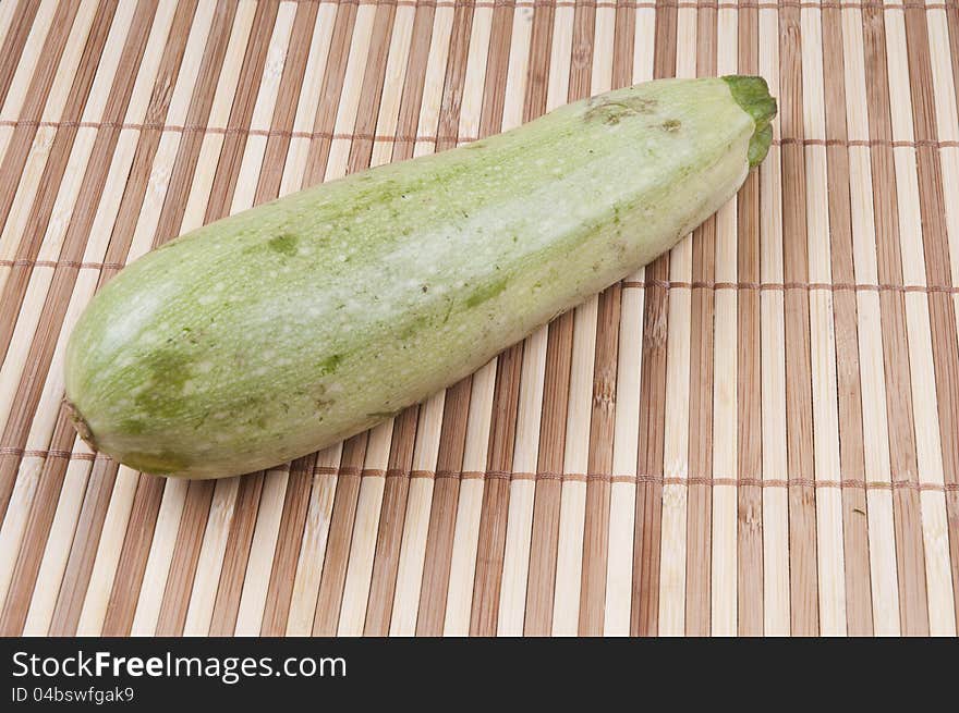 A zucchini on bamboo background