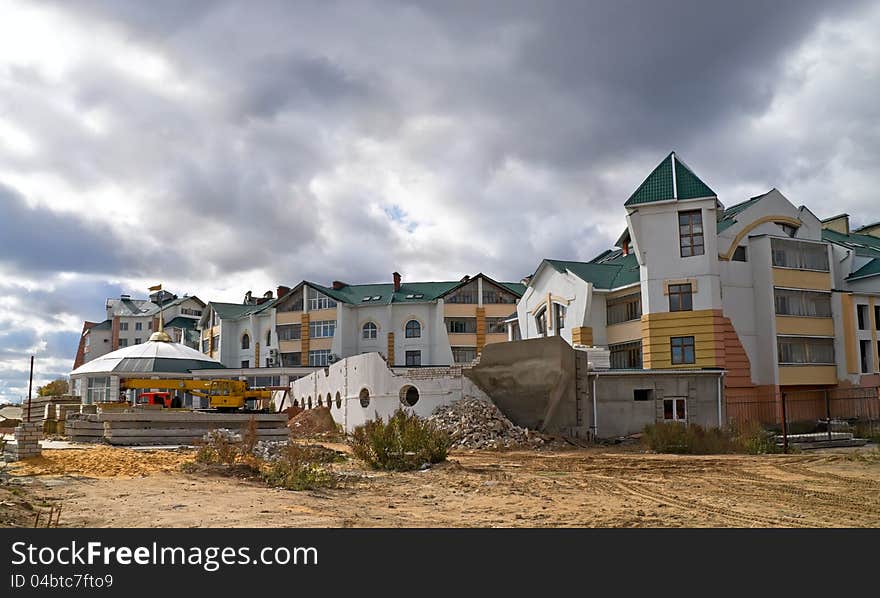 Construction of townhouse in summer landscape under cloud