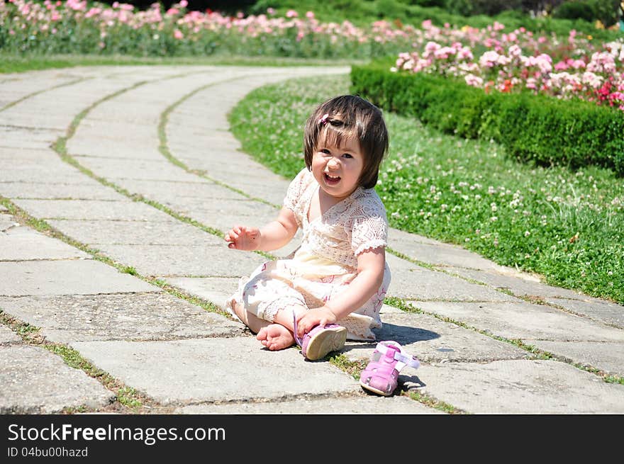 Baby girl sitting in park.