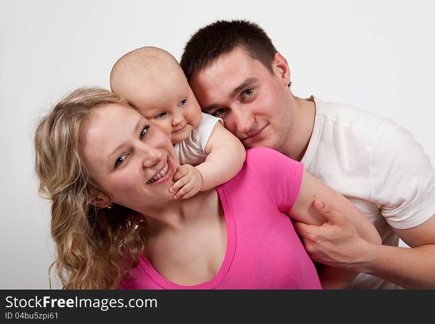 The mother and father a child on a white background. The mother and father a child on a white background