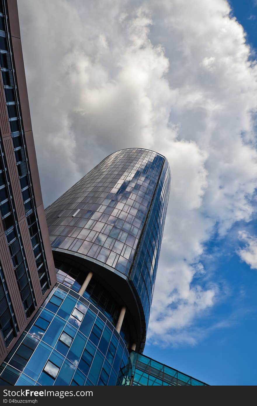 Office tower in a low angle view with attractive clouds at the sky. Office tower in a low angle view with attractive clouds at the sky