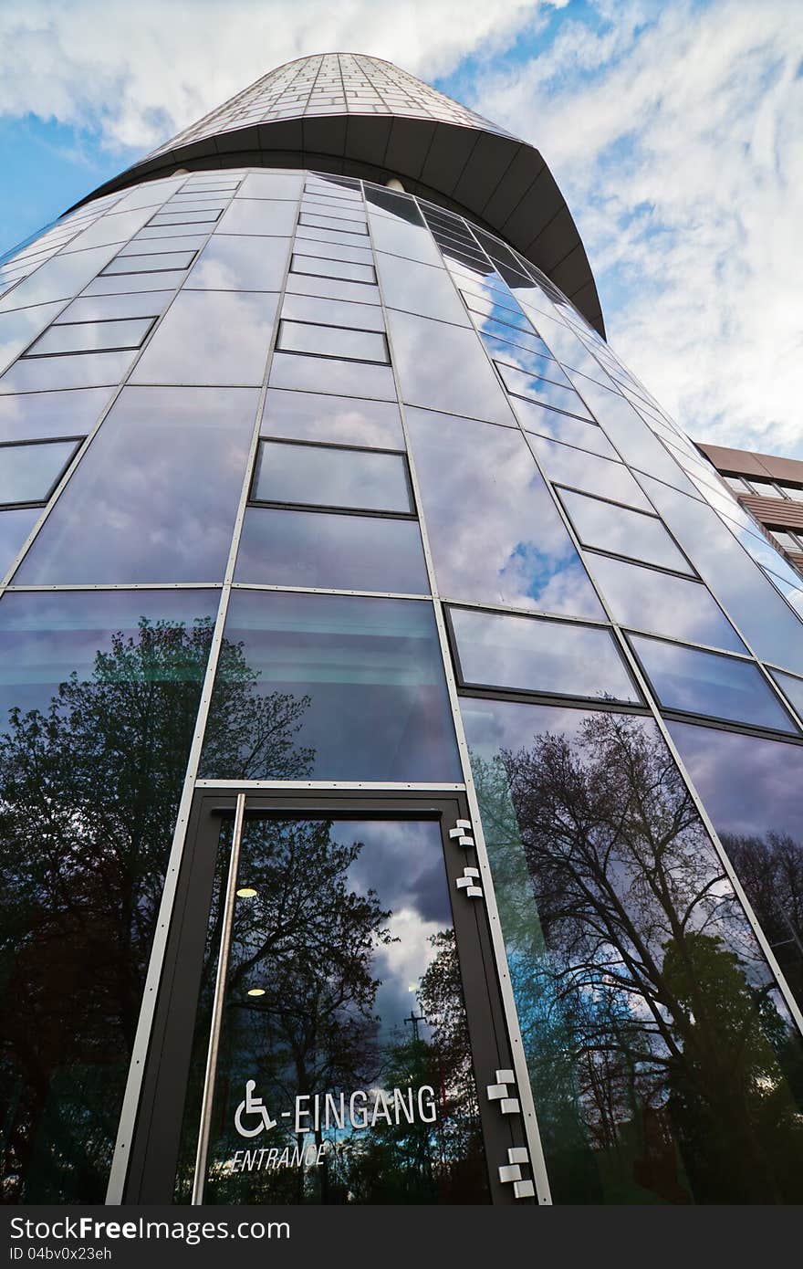 Office tower in low angle view with an entrance for handicapped people