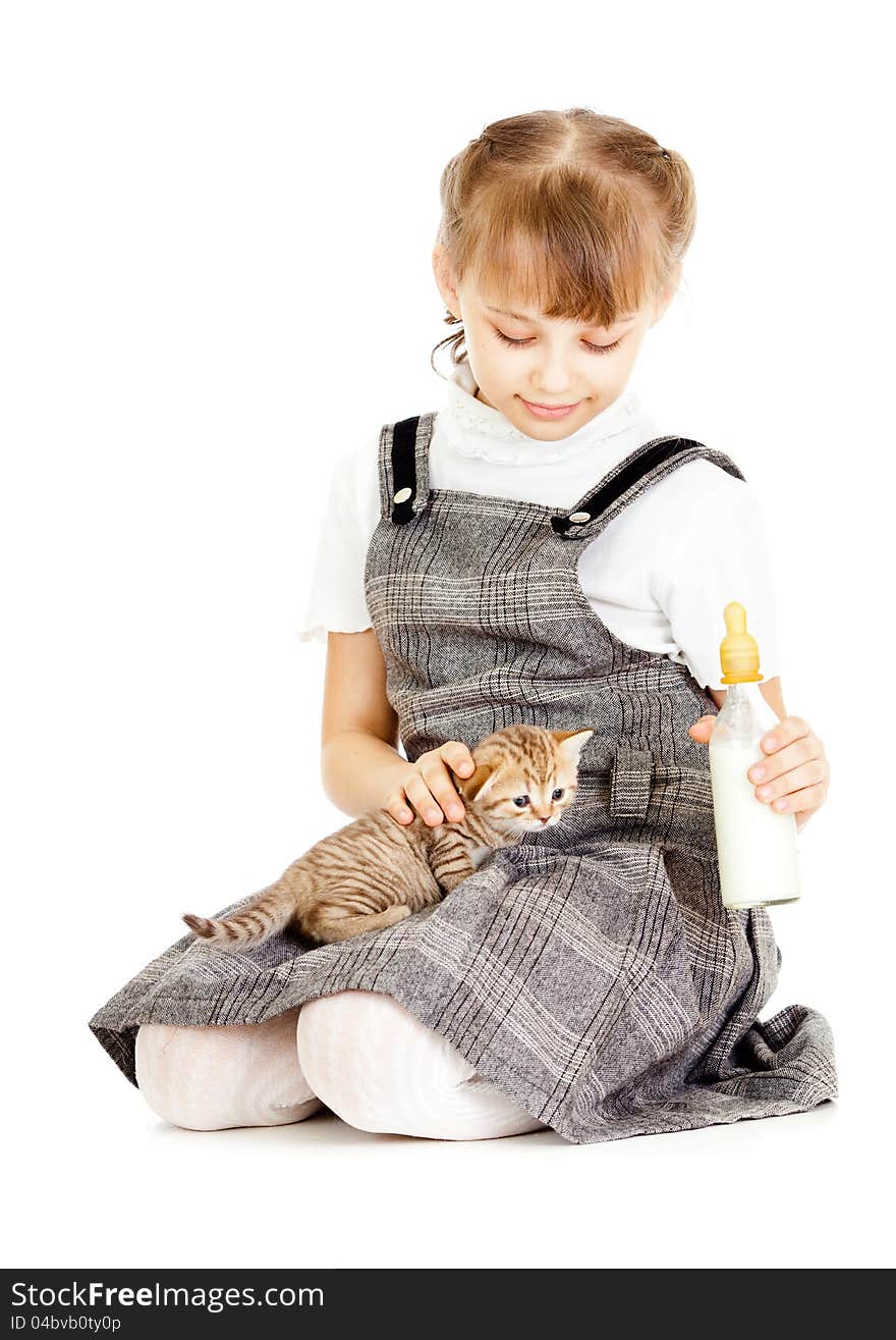 Girl feeding British kitten