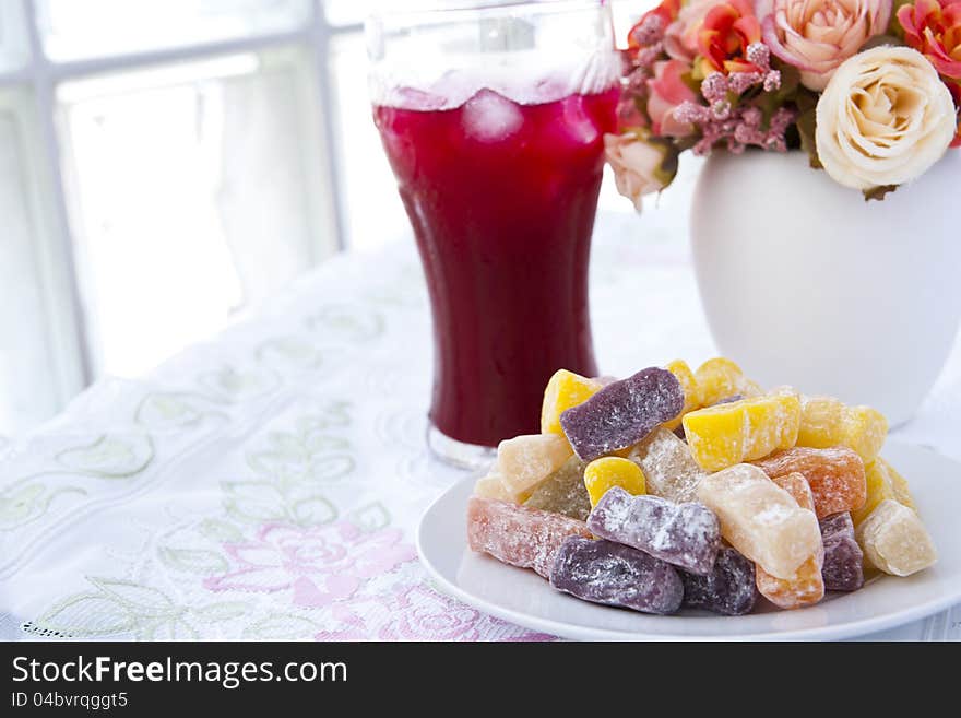 Colorful fruit jelly candy on white plate with juice. Colorful fruit jelly candy on white plate with juice