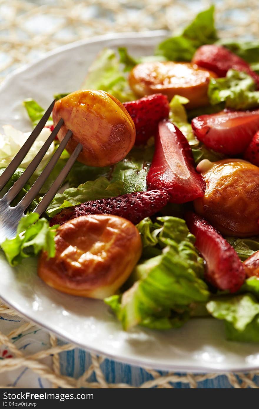 Salad with baked strawberries and roasted cheese. Salad with baked strawberries and roasted cheese