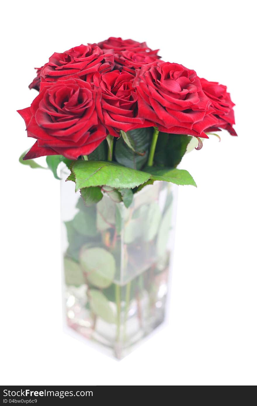 A vase with a bouquet of red roses. A vase with a bouquet of red roses