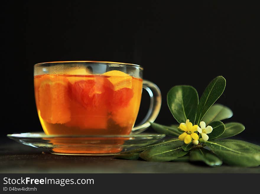 Hot tea with a flower on a black background