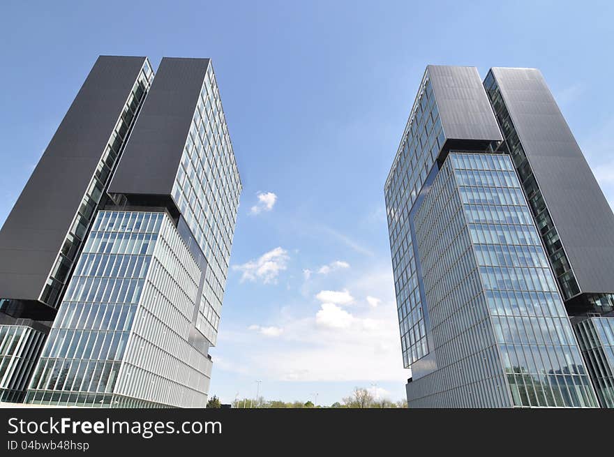 Twin towers in front of Baneasa exhibition center in Bucharest - the capital of Romania. Twin towers in front of Baneasa exhibition center in Bucharest - the capital of Romania