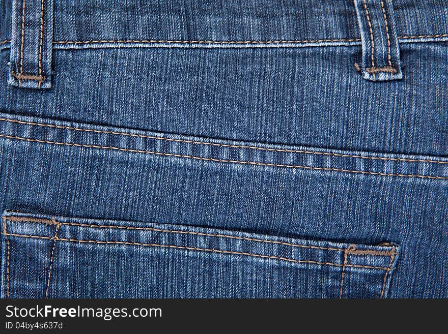 The texture of a blue denim, jeans. The texture of a blue denim, jeans