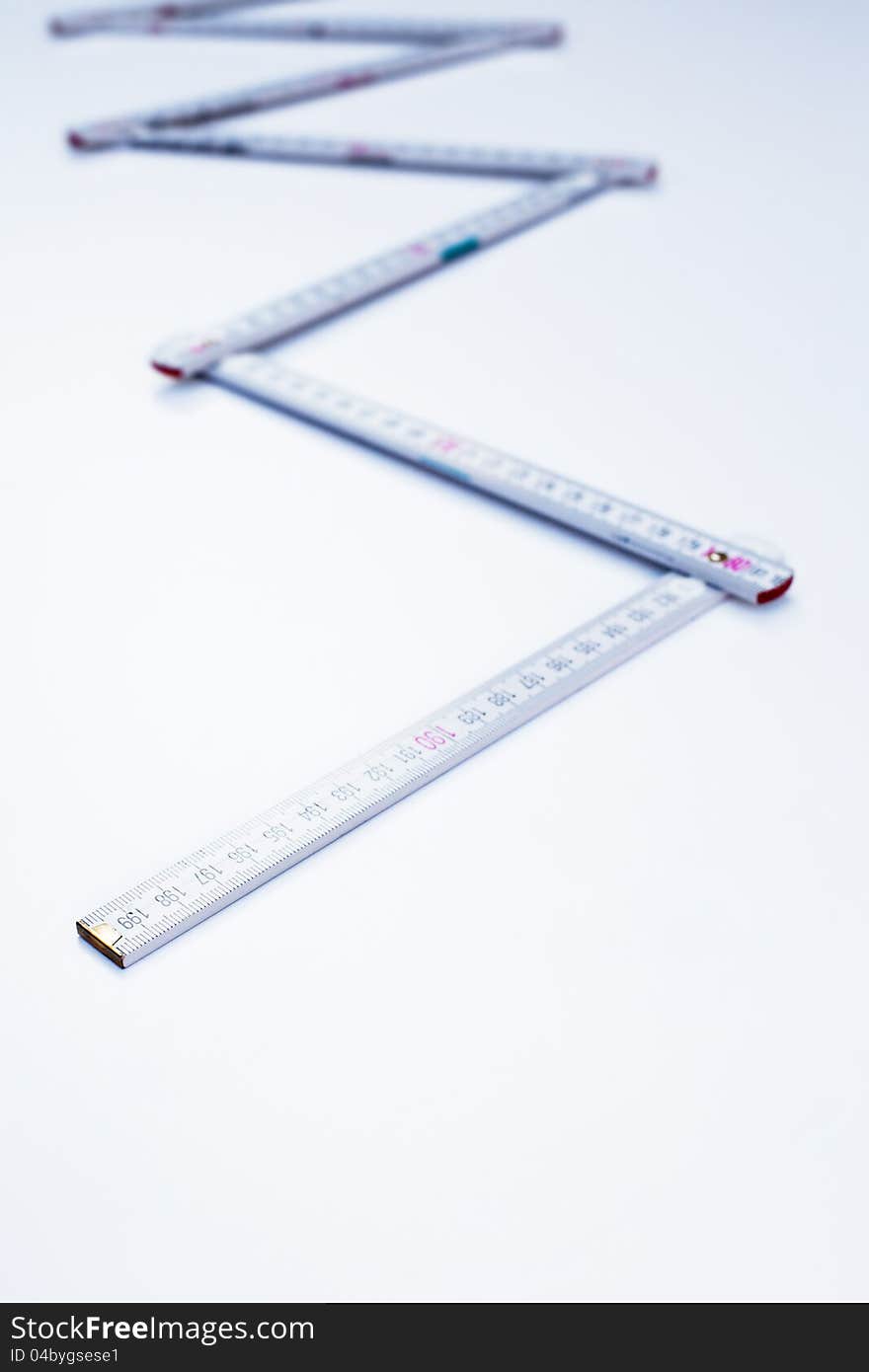 Yardstick in zigzag shape on white background