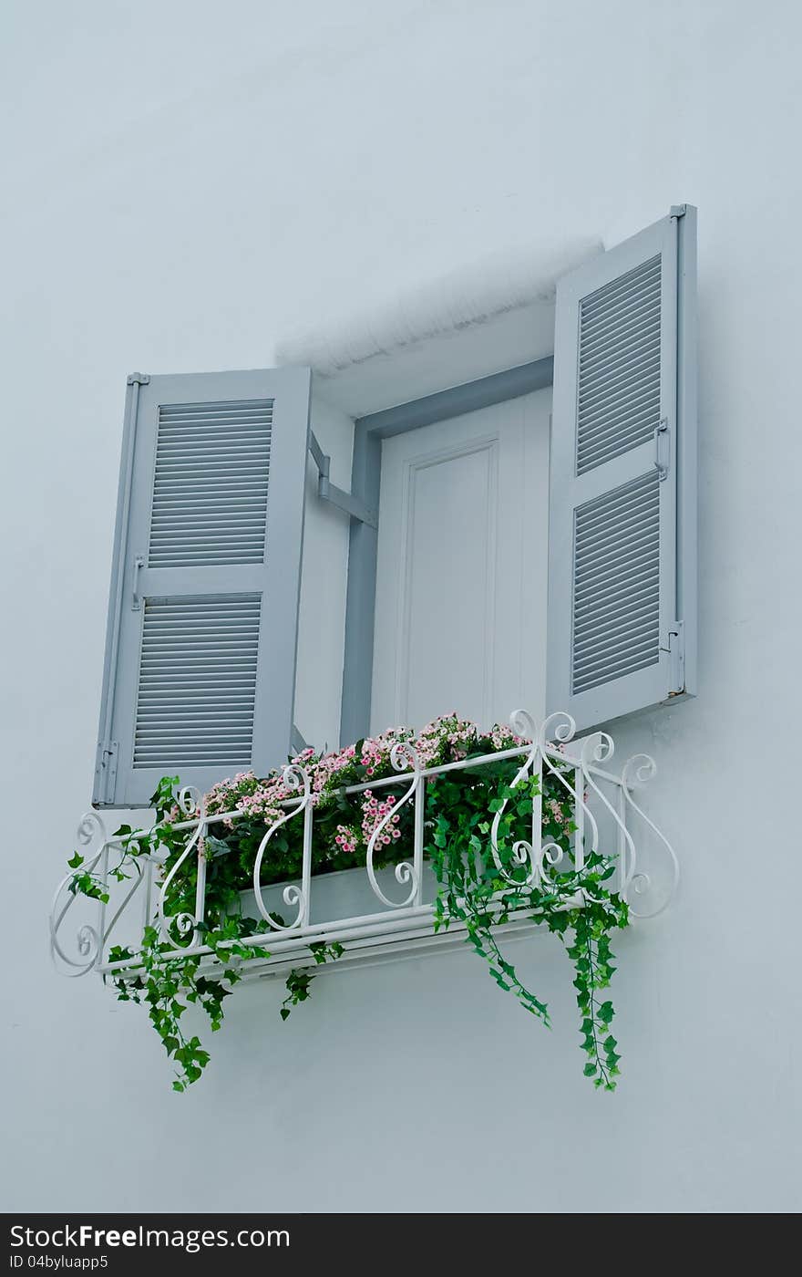 Opened gray color wood window at a house