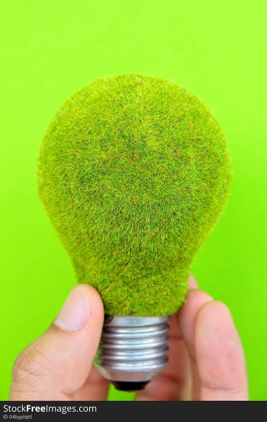 Light Blub In Hand With Green Background