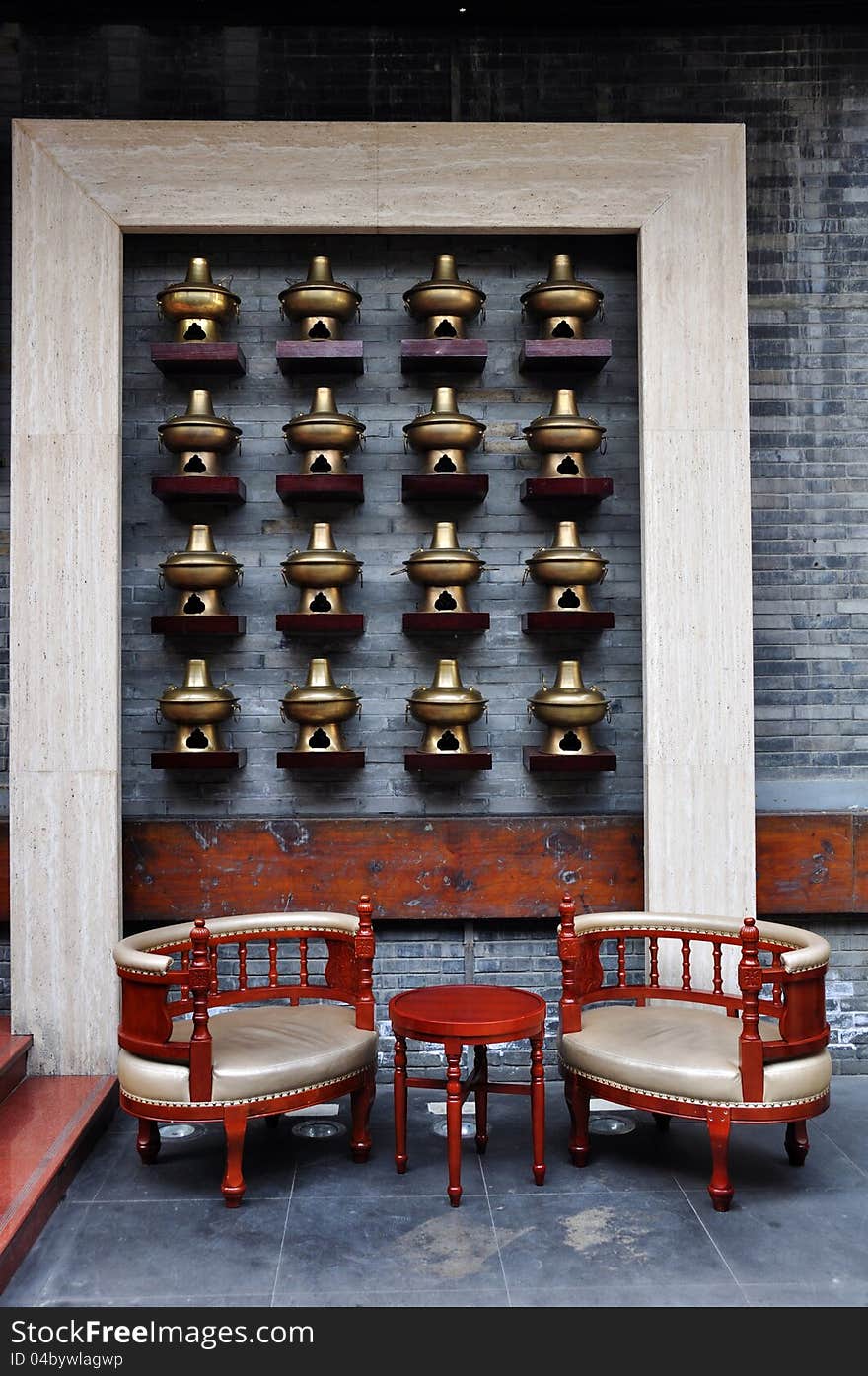 Chairs and the wall decorated with many hot pots. The photo was taken in Chengdu, Sichuan, China. Chairs and the wall decorated with many hot pots. The photo was taken in Chengdu, Sichuan, China.