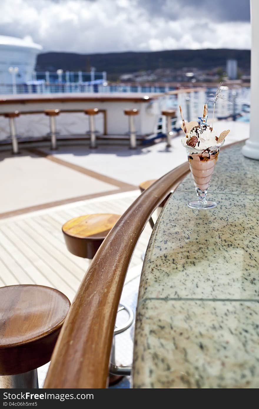 Cup of ice cream in an outdoor cafe on open deck of cruise ship