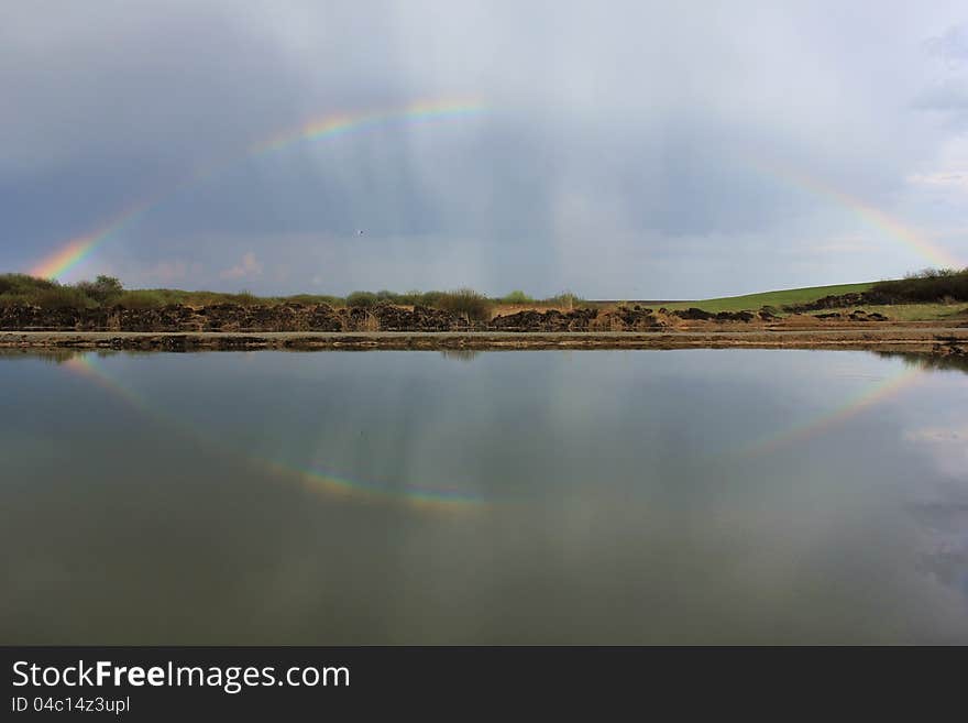 Rainbow over a fishing lake. Rainbow over a fishing lake