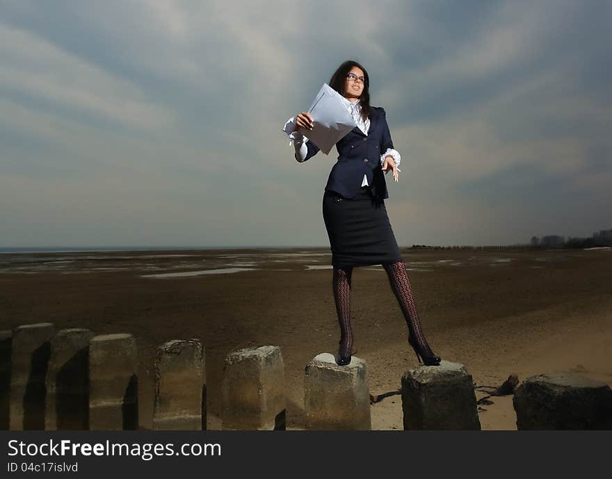 Business lady standing on the beach, on a backgrou