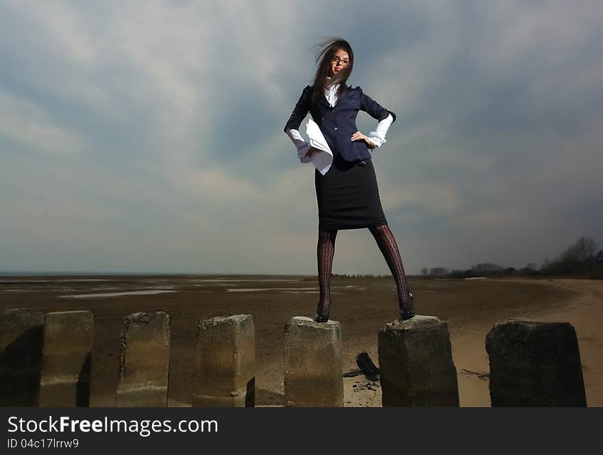 Business Lady Standing On The Beach, On A Backgrou